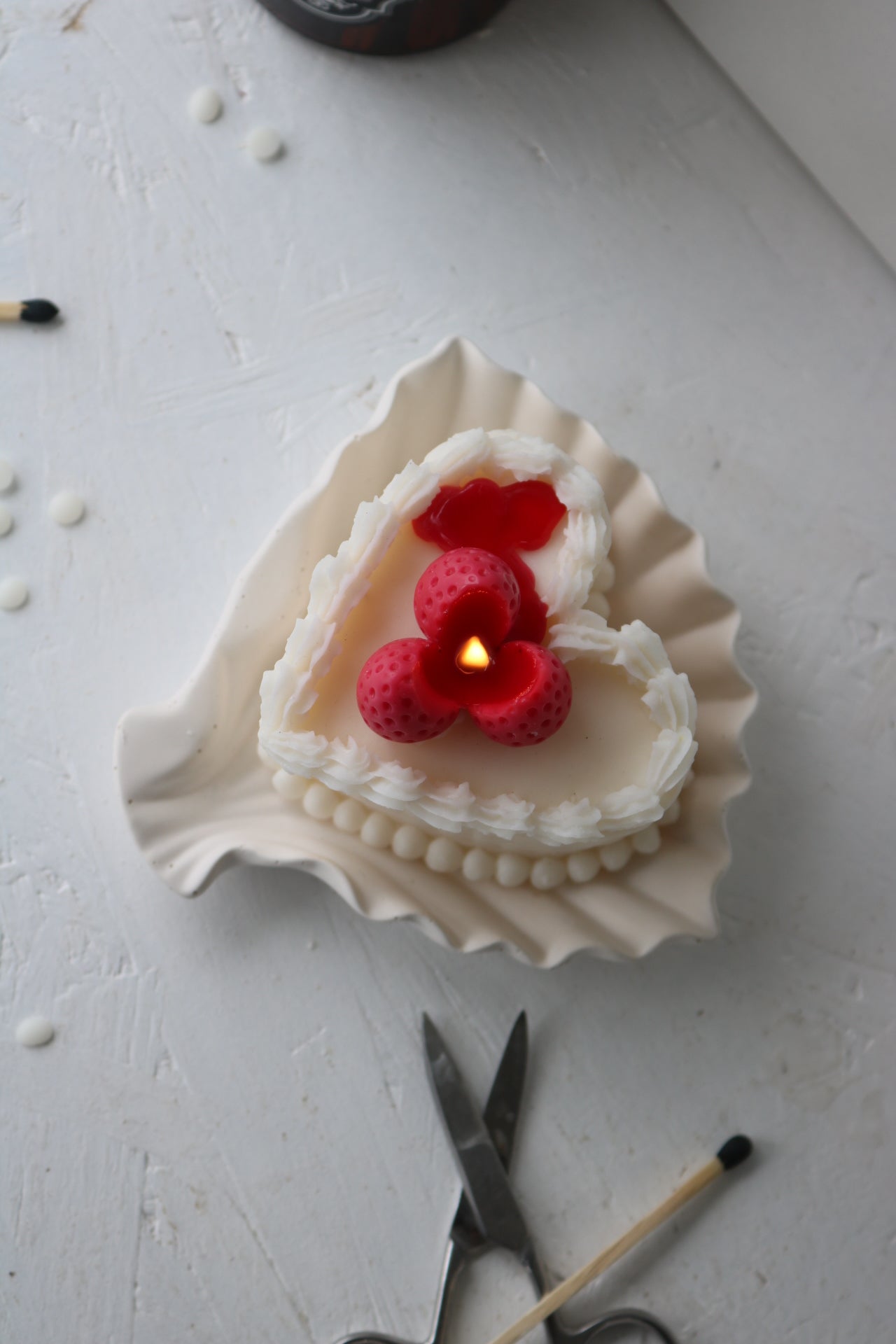 Heart cake candle with raspberry topping